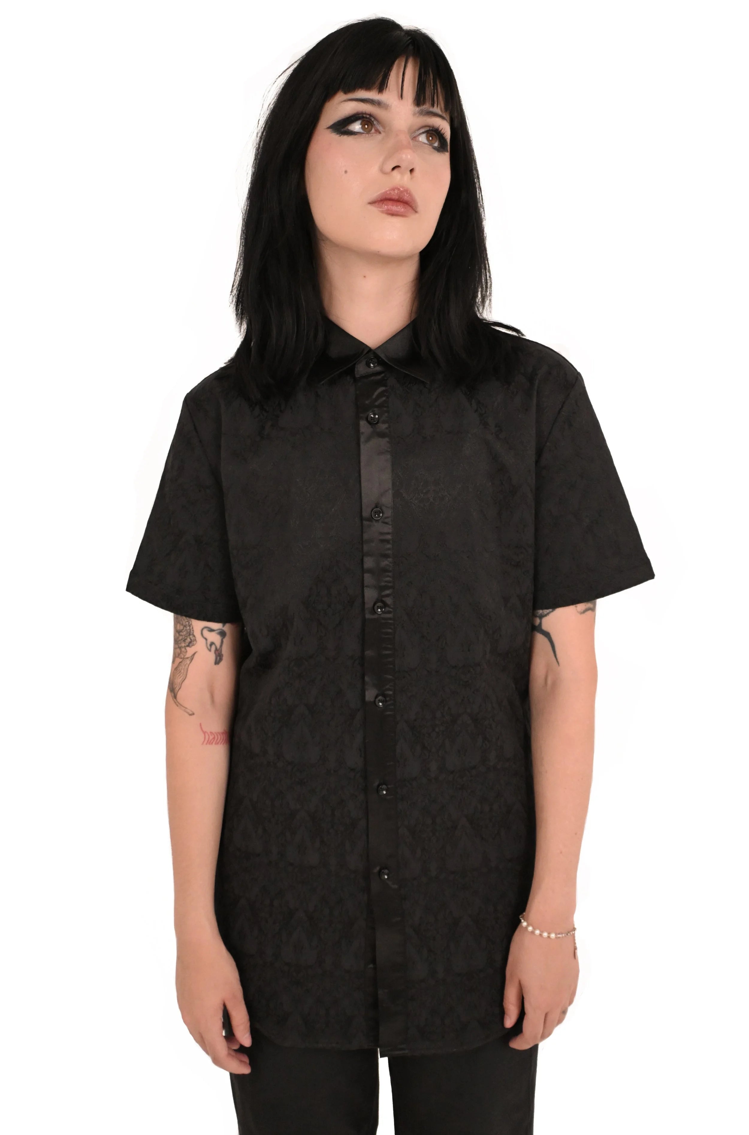 Close up of black on black damask metal print on Draven shirt