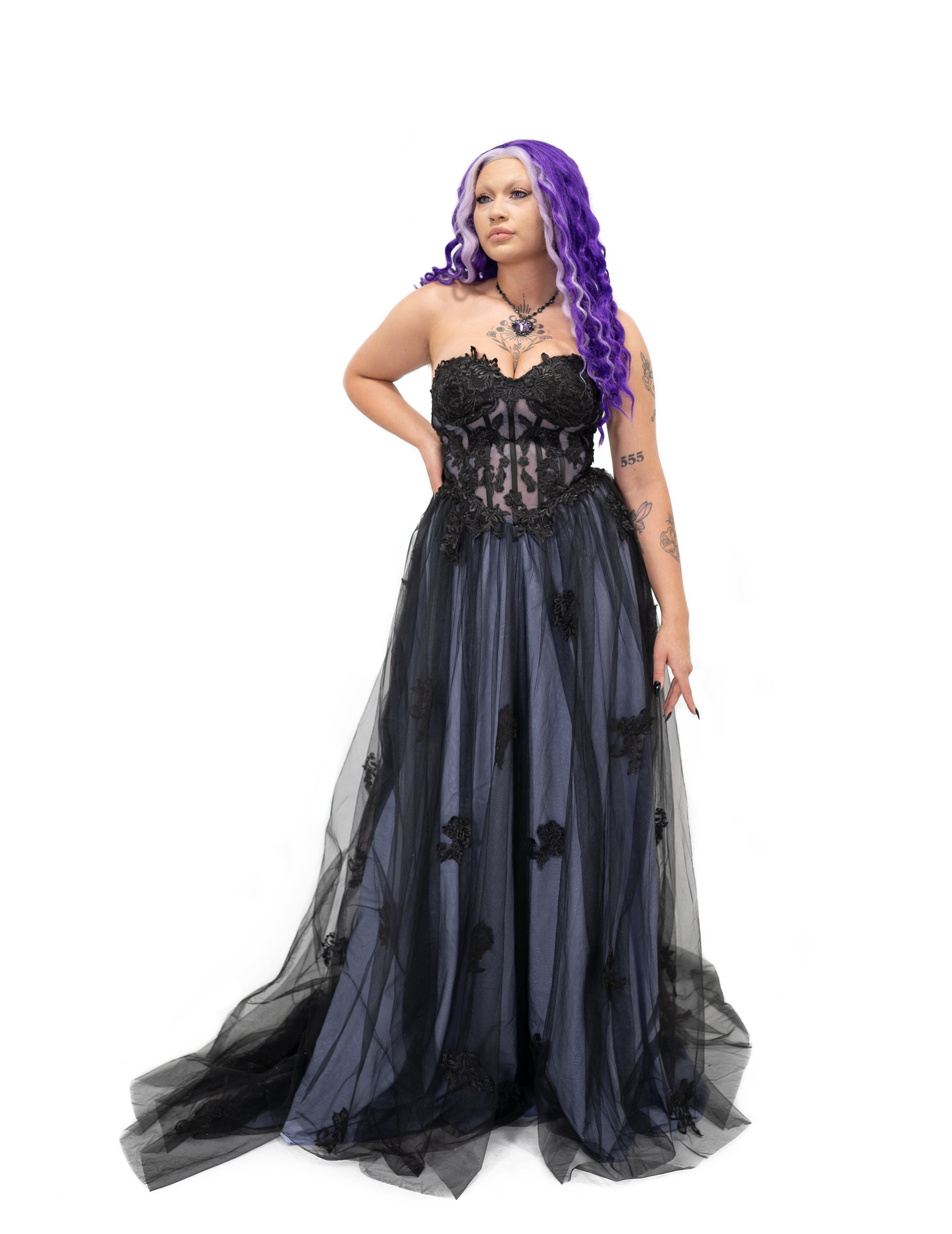 Black and light purple gothic wedding dress with a structured corset bodice and layered tulle skirt, shown from the front.