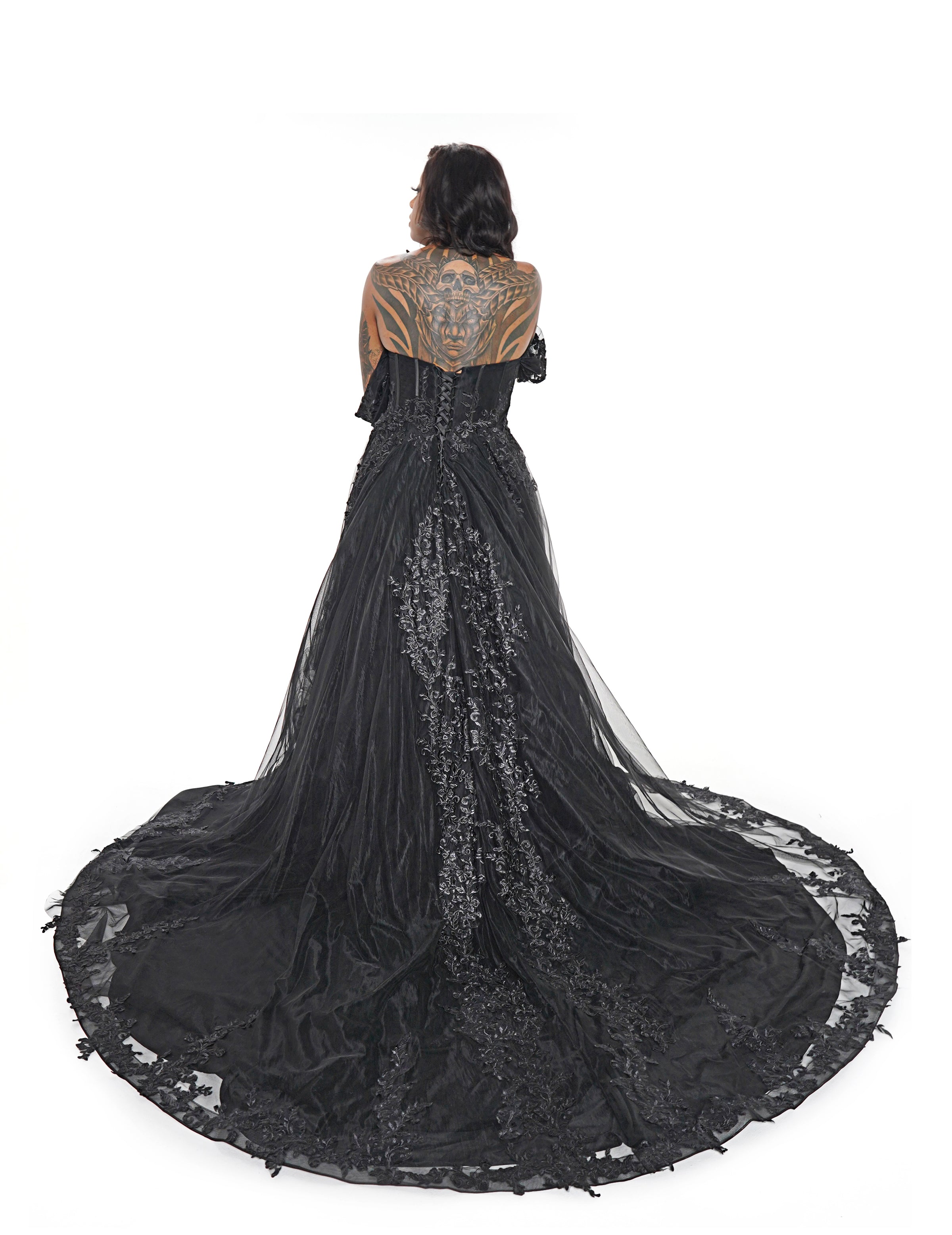 Alternative black wedding dress with dramatic sheer train and lace detailing