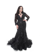 Black lace gown with sheer long sleeves and structured bodice, fitted through the hips
