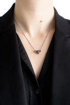 Tiny skull necklace styled with alternative gothic outfit