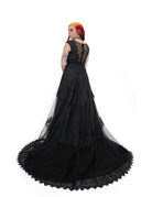 Side back view of Bête Noire Devotion gown showing layered skirt, lace trim, and long black train