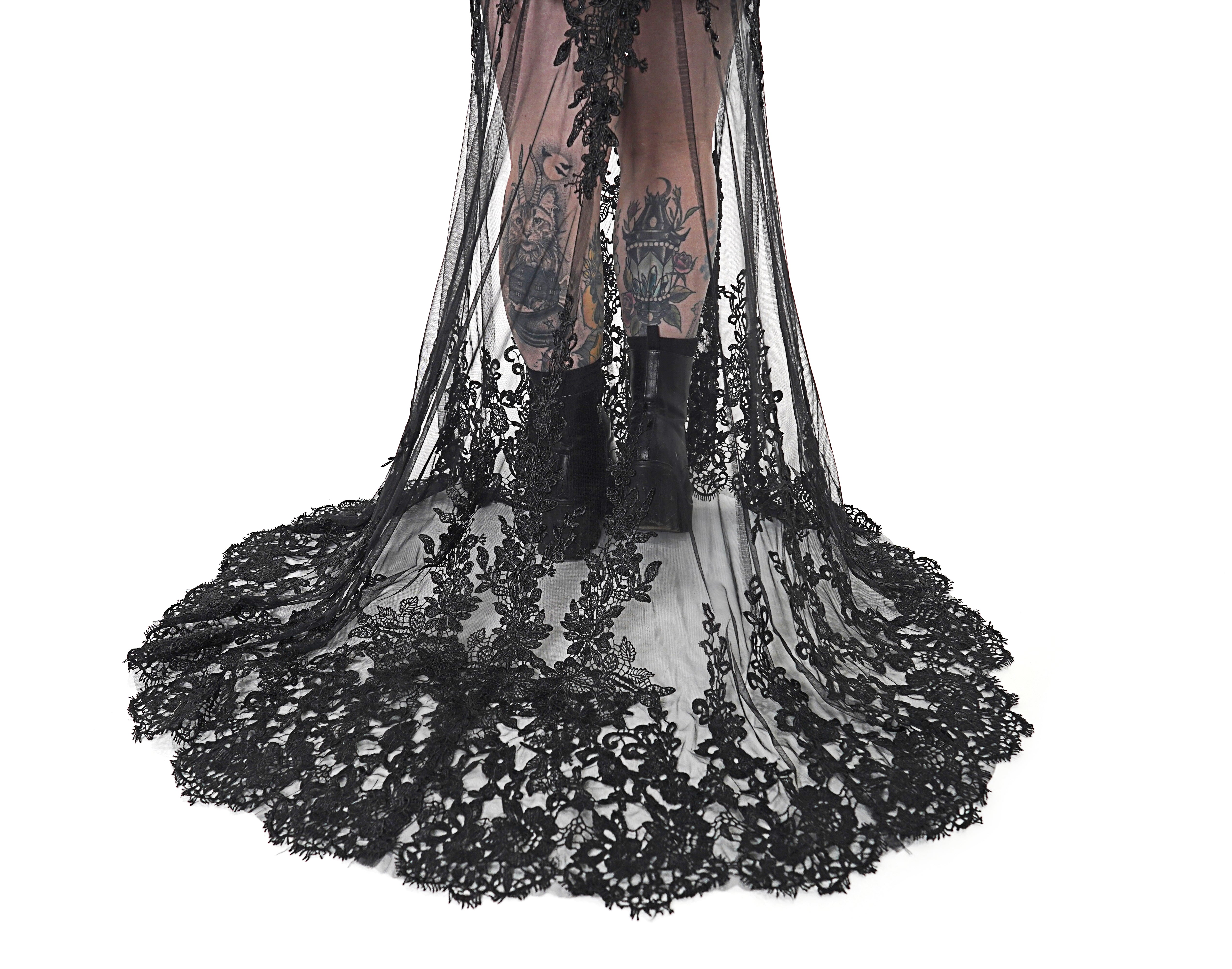 Close-up of the Kayla dress lace train with sheer tulle and detailed black floral appliqué