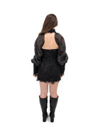 Back view of black lace mini dress with open back and sheer sleeves by Bête Noire