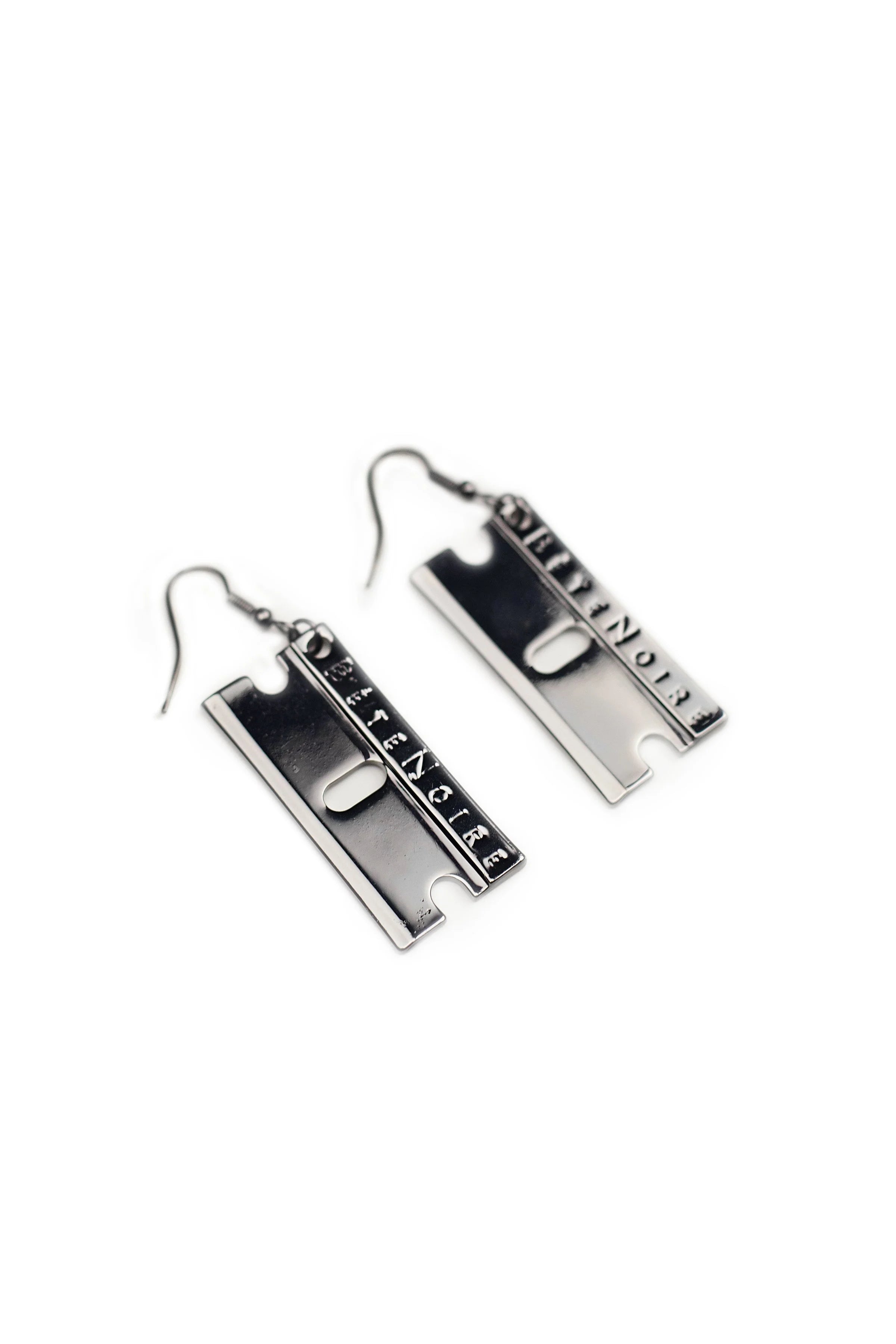 Close up of gunmetal razor blade earrings by Bête Noire