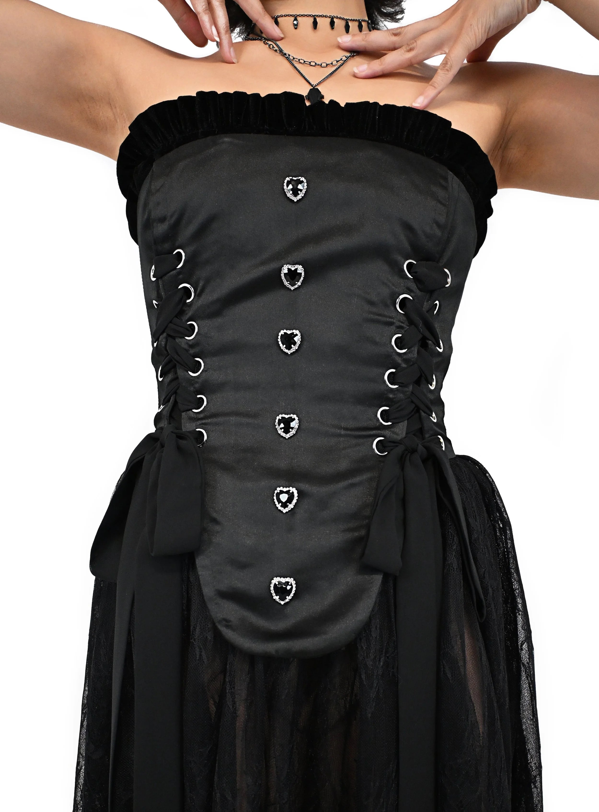Oversized bow and rhinestone heart button detail on Sacred Darkness corset