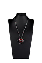 Close up of ruby gemstone Sacred Heart gothic pendant
