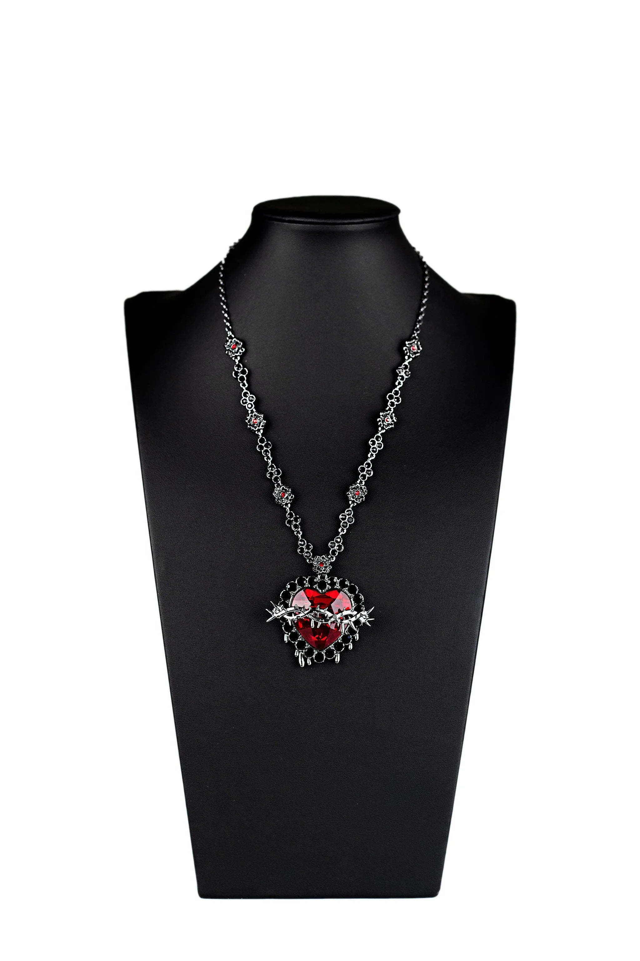 Close up of ruby gemstone Sacred Heart gothic pendant
