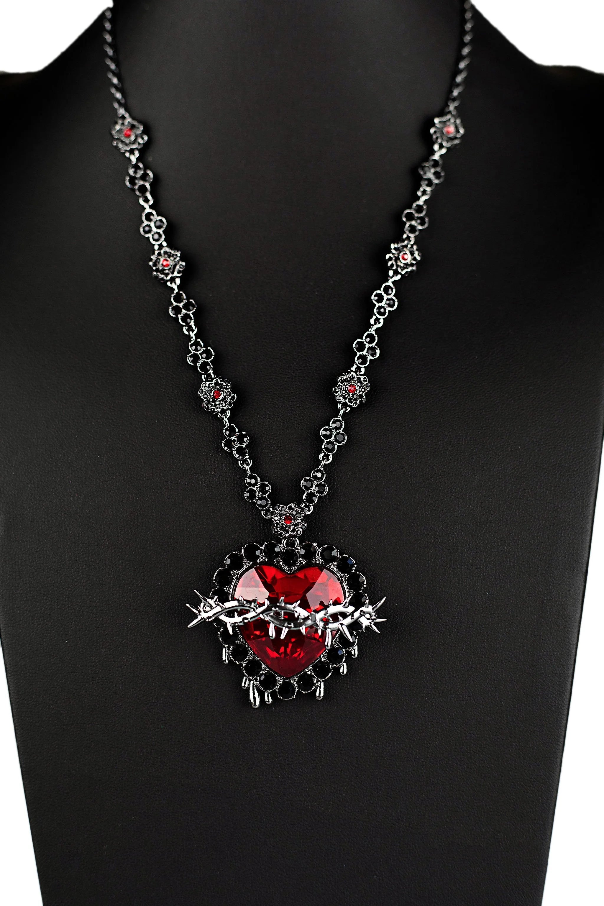 Detailed Sacred Heart pendant with ruby gemstone center