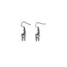 Close up of tiny tooth charm earrings by Bête Noire
