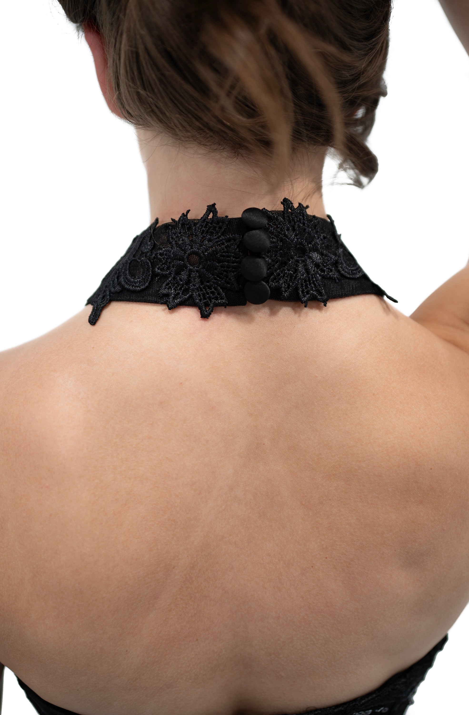 back view of black lace collar necklace with button closure and floral lace detail