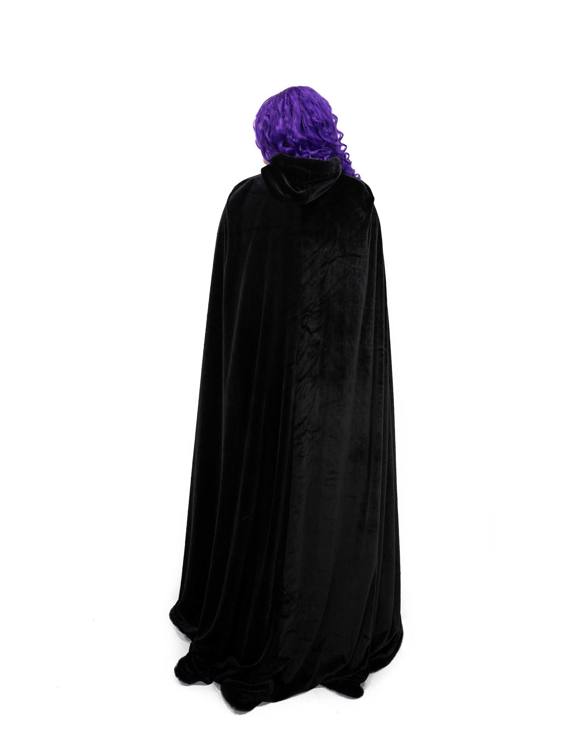 Back view of full length black velvet cape with fur trim and hood