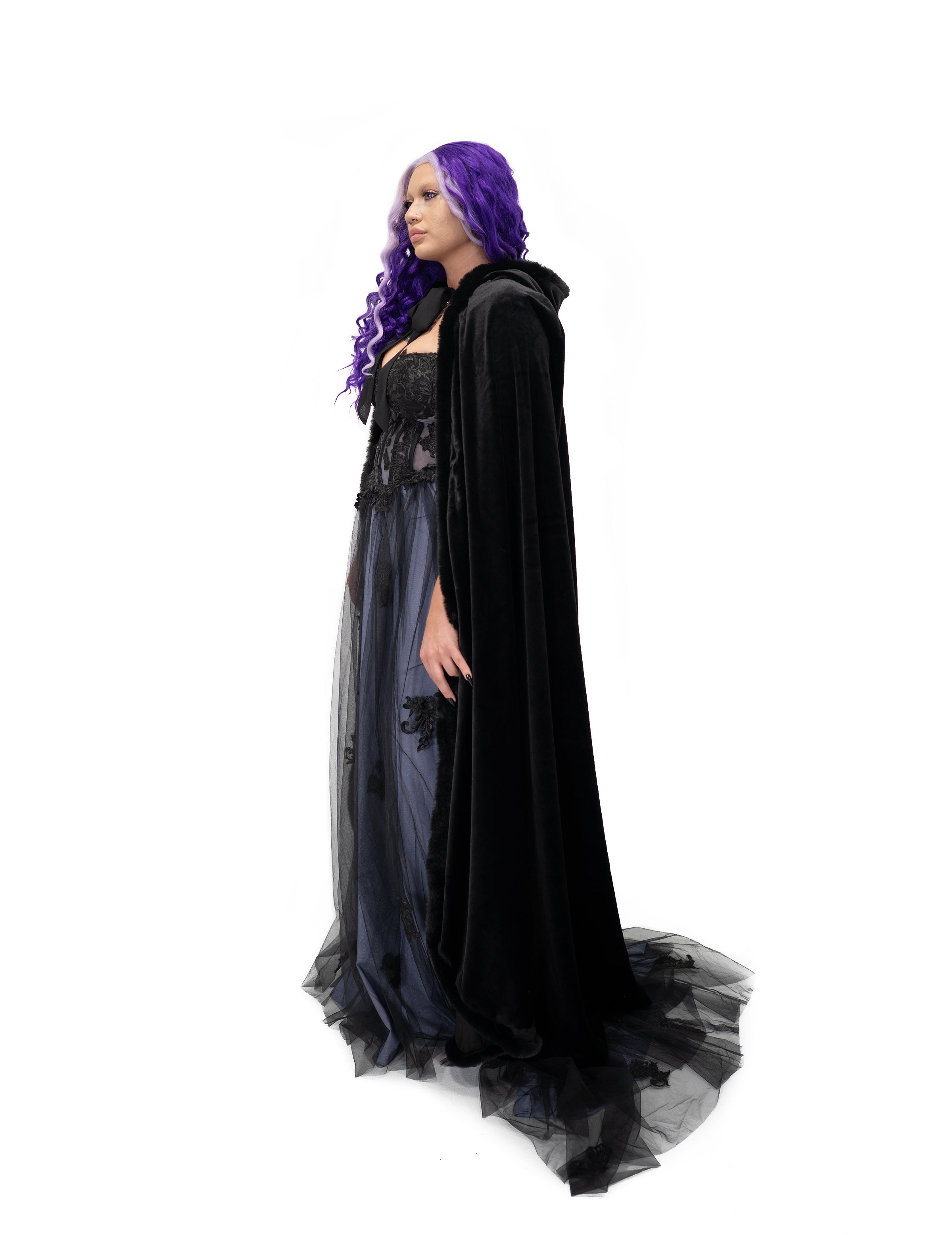 Side profile of black velvet cape with fur trim, long draped silhouette