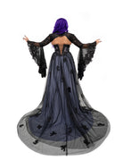 Back view of the violet gothic bridal dress with a black lace bolero featuring dramatic bell sleeves over a corset back.